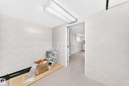 White tile walls, white ceiling, and a flush-mounted fluorescent light fixture - 3311 104 Avenue Nw, Edmonton, AB 