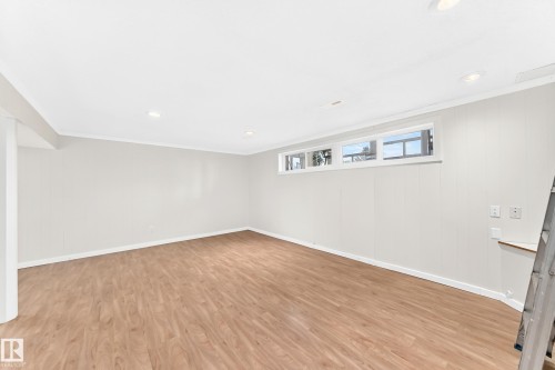 Recessed lighting, wood-finish flooring, multiple windows, and white paneling - 3311 104 Avenue Nw, Edmonton, AB 