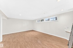 Recessed lighting, wood-finish flooring, multiple windows, and white paneling - 