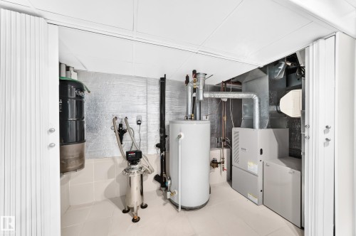 Utility area featuring a water heater, furnace, and additional water treatment systems - 3311 104 Avenue Nw, Edmonton, AB 