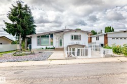 Single-story residence featuring a white vertical siding exterior and a multi-pitch roofline - 