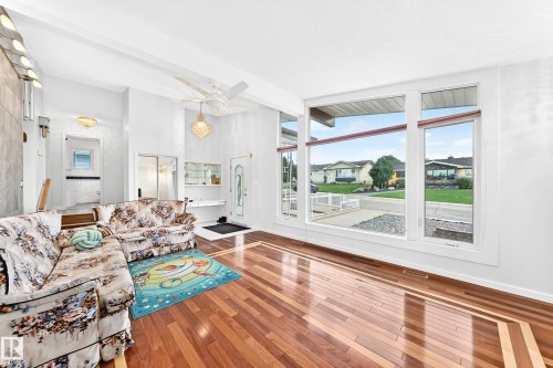 Hardwood-finish flooring with decorative inlay, large picture windows, vaulted ceilings, and a built-in display cabinet - 3311 104 Avenue Nw, Edmonton, AB 