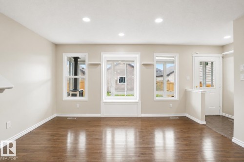 Wood-finish flooring, recessed lighting, and multiple windows with white trim - 445 Watt Boulevard Sw, Edmonton, AB 