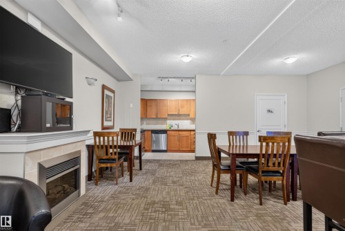 #212 2035 Grantham Ct Nw, Edmonton, AB - Indoor Photo Showing Dining Room With Fireplace