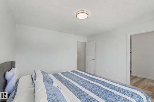 Bright interior space with white walls and a contemporary flush-mount ceiling light - #12 905 172 St Sw, Edmonton, AB - Indoor Photo Showing Bedroom