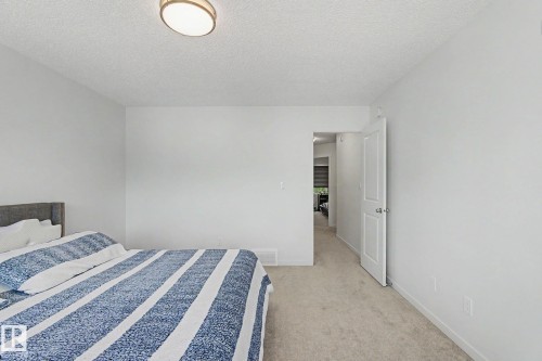 Light-filled room featuring neutral wall finishes and plush carpet flooring - #12 905 172 St Sw, Edmonton, AB - Indoor Photo Showing Bedroom