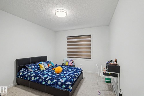Spacious room featuring neutral carpeting and white walls - #12 905 172 St Sw, Edmonton, AB - Indoor Photo Showing Bedroom
