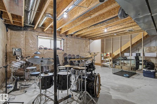 Unfinished basement with exposed ceiling joists and visible ductwork - #12 905 172 St Sw, Edmonton, AB - Indoor Photo Showing Basement