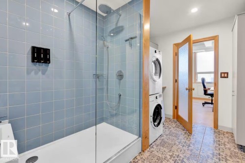 Glass-enclosed shower with blue tiled walls and a white shower base - #903 10105 109 St Nw, Edmonton, AB 