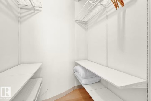White shelving system, wire shelving, and wood-finish flooring - #903 10105 109 St Nw, Edmonton, AB 