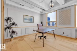 Hardwood flooring, decorative wall molding, exposed ductwork, large windows, and a ceiling-mounted light fixture - 