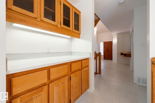 Built-in cabinetry with glass-front uppers and under-cabinet lighting - 14 Highlands Place, Wetaskiwin, AB 