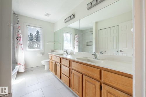 Dual vanity with wood-finish cabinetry and integral sinks - 14 Highlands Place, Wetaskiwin, AB 