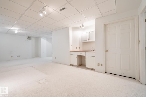 Expansive carpeted area with a drop ceiling and recessed lighting - 14 Highlands Place, Wetaskiwin, AB 