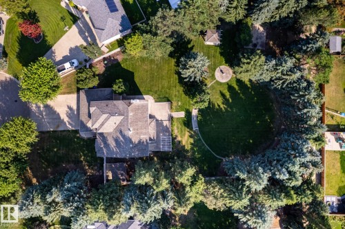 Expansive backyard featuring a manicured lawn, mature trees, and a gazebo - 14 Highlands Place, Wetaskiwin, AB 