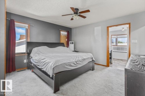 Carpeting throughout, ceiling fan, and wood-trim windows - 8015 158 Ave Nw, Edmonton, AB 