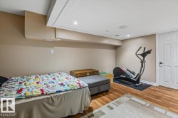 Recessed lighting, wood-finish flooring, white paneled door, neutral wall color, and a finished ceiling - 