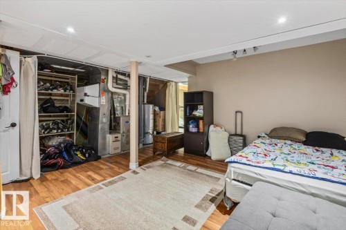 Wood-finish flooring with recessed lighting and track lighting - 8015 158 Ave Nw, Edmonton, AB 