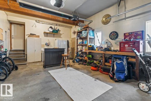 Concrete flooring with exposed wood beams, multiple windows, and integrated overhead lighting - 8015 158 Ave Nw, Edmonton, AB 