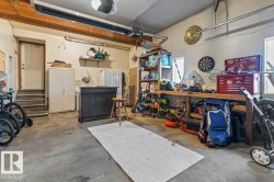Concrete flooring with exposed wood beams, multiple windows, and integrated overhead lighting - 