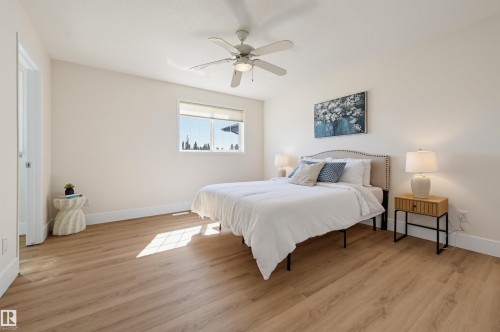 Wood-finish flooring, overhead ceiling fan with lighting, and a window with roller shades - 839 Blacklock Way Sw, Edmonton, AB 