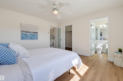 Wood-finish flooring, ceiling fan, and white baseboards - 839 Blacklock Way Sw, Edmonton, AB 