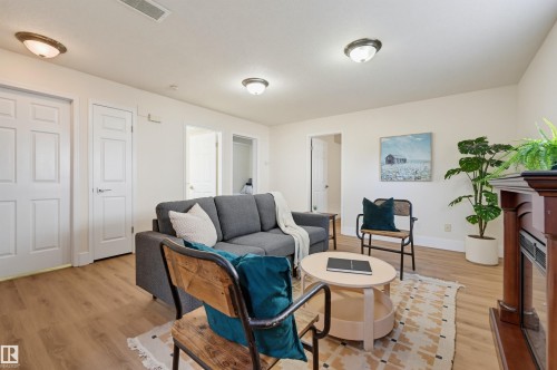 Wood-finish flooring throughout, bright white walls, and flush-mount ceiling lighting - 839 Blacklock Way Sw, Edmonton, AB 