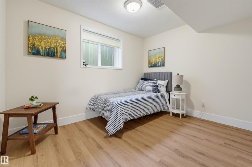 Recessed ceiling light fixture, wood-finish flooring, white trim, and a window with blinds - 839 Blacklock Way Sw, Edmonton, AB 