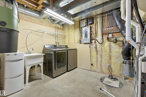 Laundry area featuring a utility sink, a clothes drying rack, and exposed overhead utilities - 839 Blacklock Way Sw, Edmonton, AB 