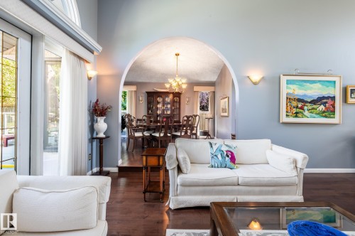 Vaulted ceiling, arched doorway, hardwood flooring, sliding glass doors, and wall sconces - 8 Edgemont Point(E), St. Albert, AB 