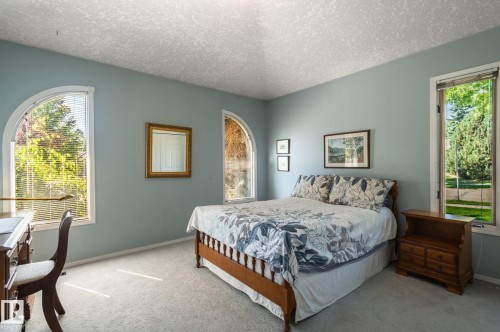 Arched windows, light blue wall paint, and gray carpeting - 8 Edgemont Point(E), St. Albert, AB 