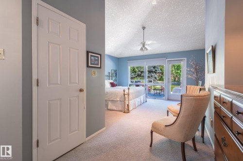 Sliding glass doors opening to an exterior patio, accompanied by a single door - 8 Edgemont Point(E), St. Albert, AB 