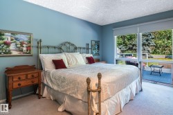 Carpeted flooring, light blue wall paint, and direct deck access with exterior landscaping - 