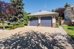 Attached two-car garage with overhead doors and exterior lighting - 