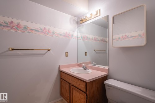 Vanity with an integrated sink and wood-finish cabinetry - 8 Edgemont Point(E), St. Albert, AB 