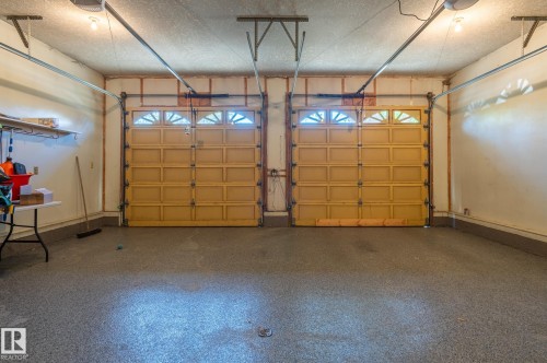 Two-car garage with two paneled garage doors featuring upper window inserts - 8 Edgemont Point(E), St. Albert, AB 
