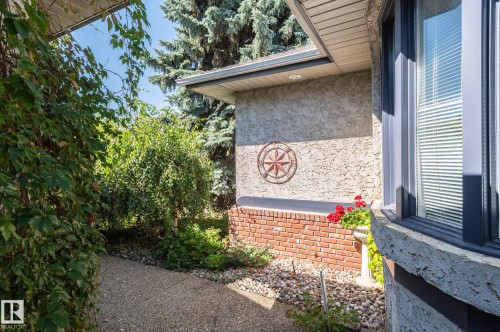 Stucco exterior with a brick foundation accent, bay window, and integrated soffit lighting - 8 Edgemont Point(E), St. Albert, AB 