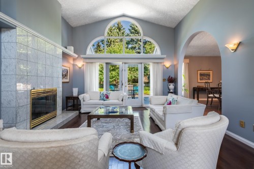 Vaulted ceiling, arched transom windows, French doors, fireplace with tile surround, and an arched entry - 8 Edgemont Point(E), St. Albert, AB 
