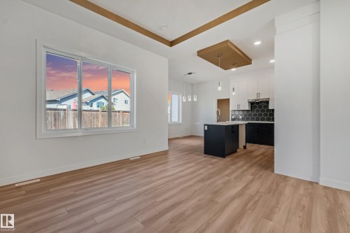 Open concept living area with wood-finish flooring - 32 Dalquist Bay, Leduc, AB 