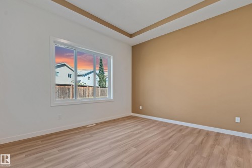 Recessed ceiling detail, wood-finish flooring, large window, two-tone wall finish, white trim - 32 Dalquist Bay, Leduc, AB 
