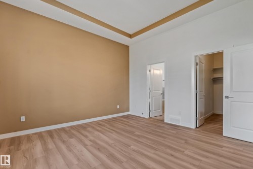 Wood-finish flooring with a tray ceiling detail - 32 Dalquist Bay, Leduc, AB 