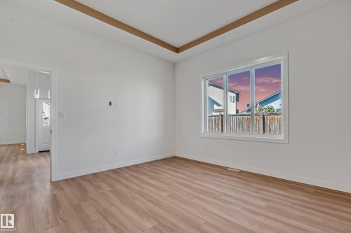 Wood-finish flooring, white walls, and a large window with white trim - 32 Dalquist Bay, Leduc, AB 