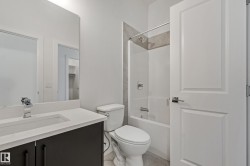 Integrated vanity with a rectangular basin sink, chrome faucet, and dark wood-finish cabinetry - 