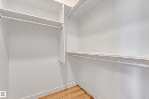 Built-in shelving, multiple hanging rods, wood-finish flooring - 32 Dalquist Bay, Leduc, AB 