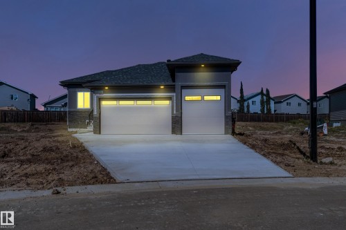 Contemporary exterior with gray siding and stone accents - 32 Dalquist Bay, Leduc, AB 