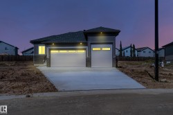 Contemporary exterior with gray siding and stone accents - 