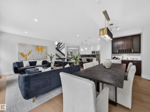 Open-concept living space with light wood-finish flooring - #59 10550 Ellerslie Rd Sw, Edmonton, AB - Indoor