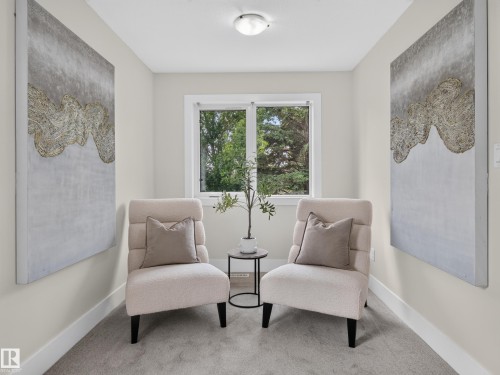Recessed alcove featuring a window, light gray carpeting, and white baseboards - #59 10550 Ellerslie Rd Sw, Edmonton, AB - Indoor Photo Showing Other Room
