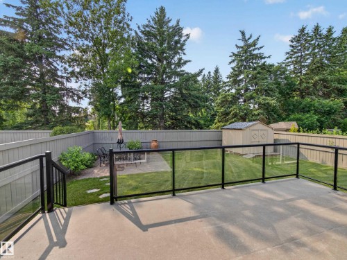 Spacious concrete patio with black aluminum and glass railing - #59 10550 Ellerslie Rd Sw, Edmonton, AB - Outdoor