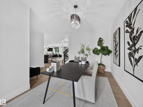 Bright interior space featuring light wood-finish flooring, white walls, and recessed lighting - #59 10550 Ellerslie Rd Sw, Edmonton, AB - Indoor Photo Showing Dining Room